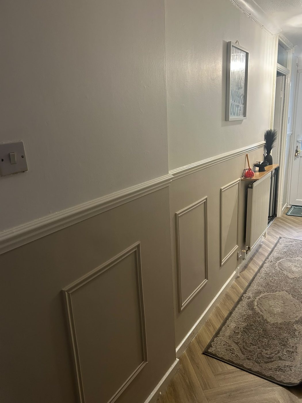 Hallway with painted wall panelling and dado rail in warm grey, in a Hurst Green home